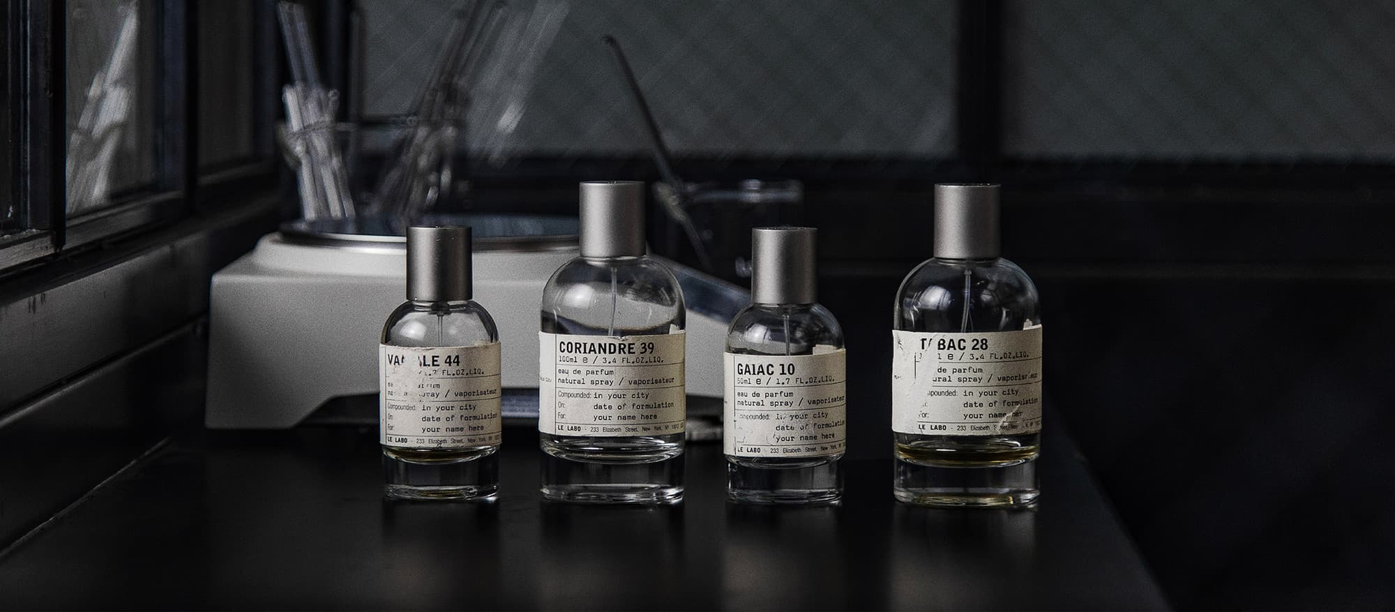 Le Labo packaging on a vintage desk